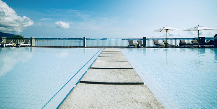 walkway-though-a-clear-swimming-pool-near-the-ocean